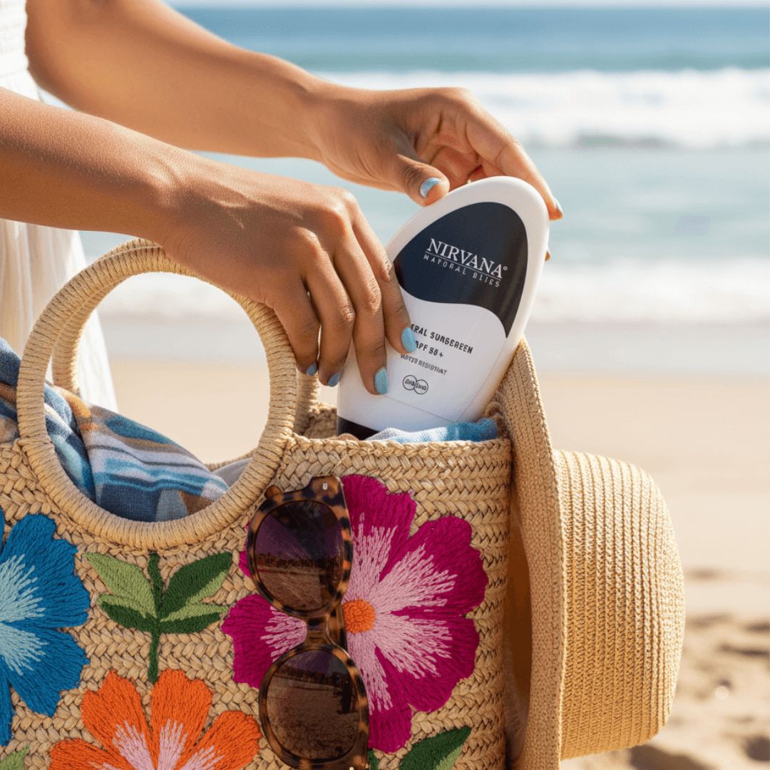 Person putting Nirvana sunscreen into a floral bag on a beach
